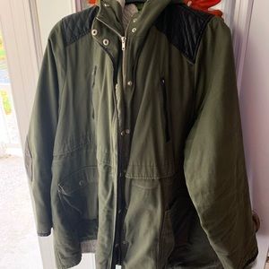 Olive green torrid winter coat with black leather detail.